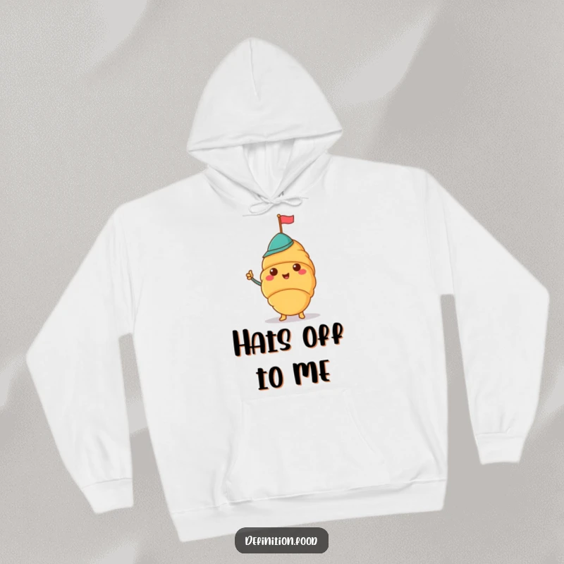 Funny hoodie featuring a cheerful croissant wearing a jaunty hat and waving a tiny flag, perfect for comfort.